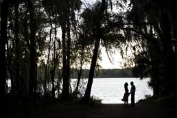 silhouette of couple by lake